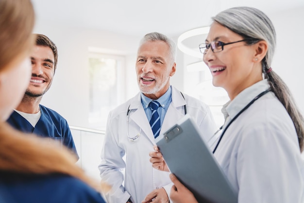 Happy medical staff talking in hospital corridor