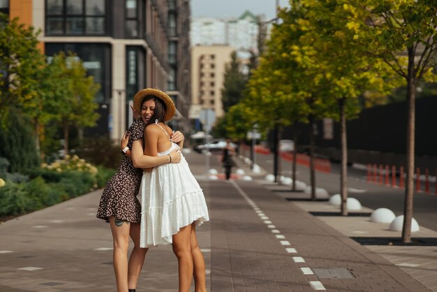 Happy meeting of two friends hugging in the street