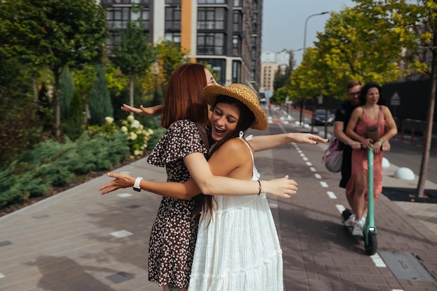 Happy meeting of two friends hugging in the street