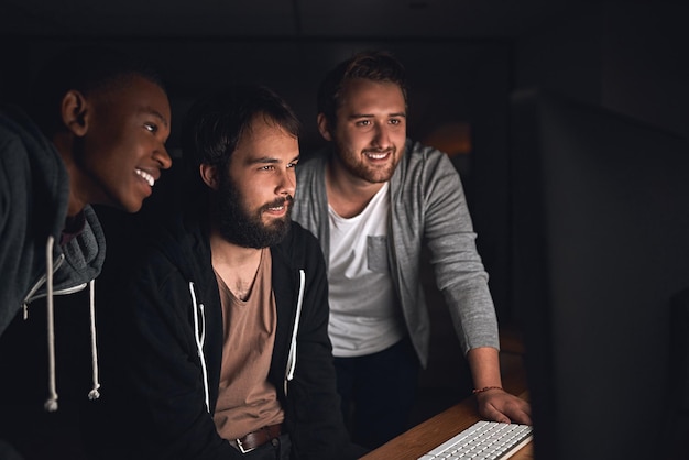 happy men and programmers for software development coding and collaboration at night in office smile people and web design for app project meeting for update to script or algorithm and teamwork