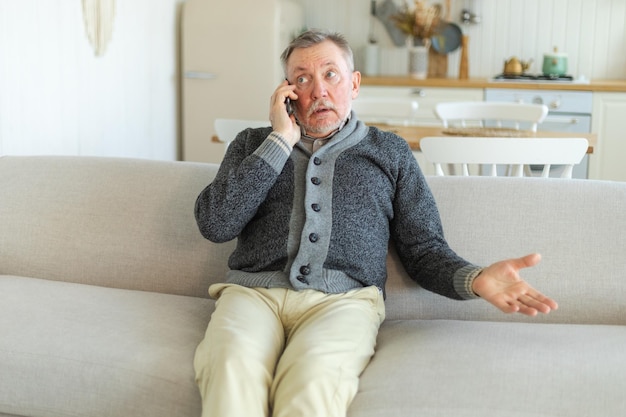 Happy middle aged senior man talking on smartphone with family friends older mature grandfather with