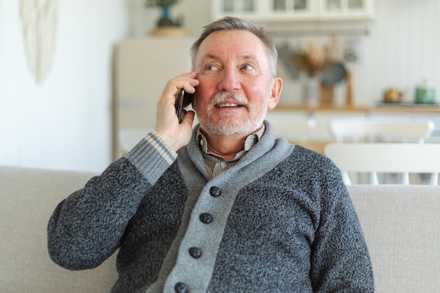 Happy middle aged senior man talking on smartphone with family friends older mature grandfather with