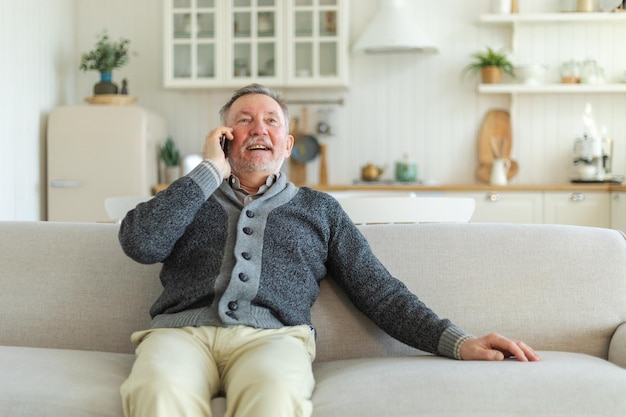 Happy middle aged senior man talking on smartphone with family friends older mature grandfather with