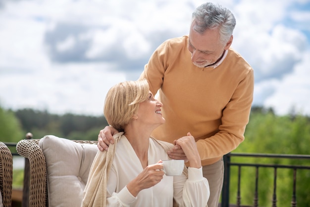 Happy middle-aged woman enjoying her husbands care