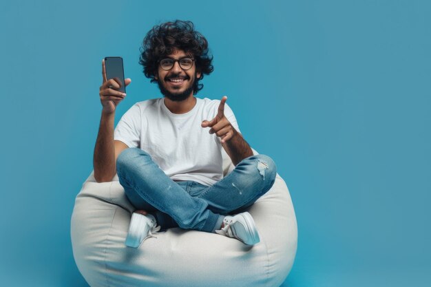 Happy millennial man with new smartphone pointing at offer