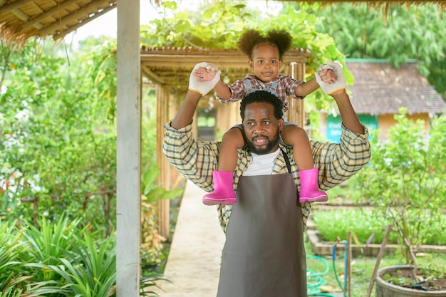 Happy Mixed race father and little girl agronomist enjoying and working in farmland agriculture concept