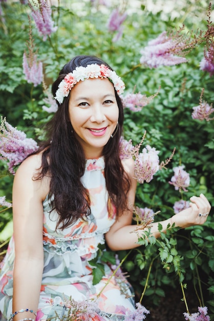 Happy mixedrace japanese woman with flower hair band in\
garden