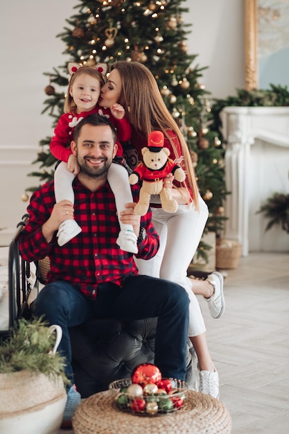 Happy mom dad and children lying down on bed at home