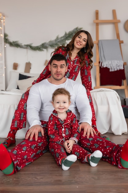 Happy mom dad and daughter The morning before christmas