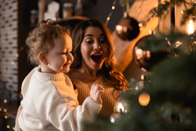 Happy mom and daughter The morning before Christmas Portrait of a loving family