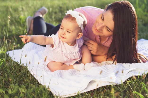 Happy mom and daughter playing at nature