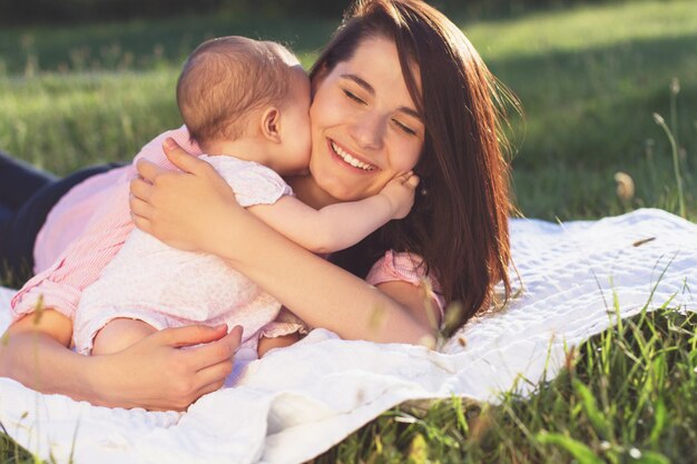 Happy mom and daughter playing at nature