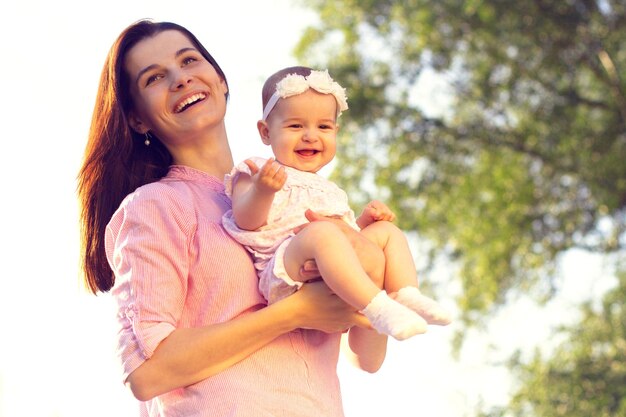 Happy mom and daughter playing at nature