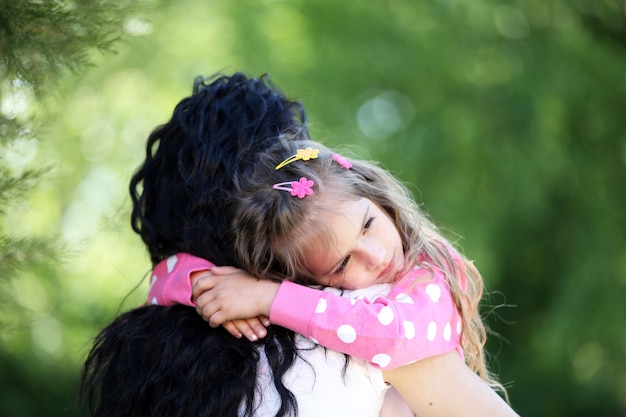 Happy mom and daughter. Walk in the green park