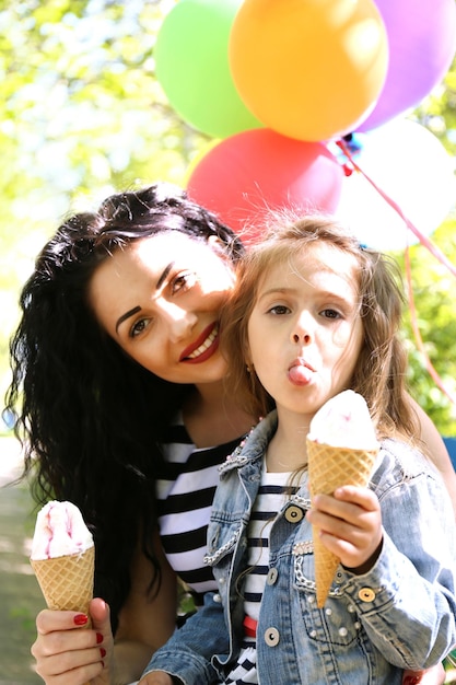 Happy mom and daughter Walk in the green park