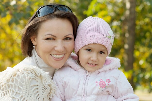 Happy mom and a little girl in the autumn