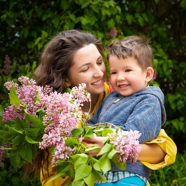 Happy mom with baby with flowers.