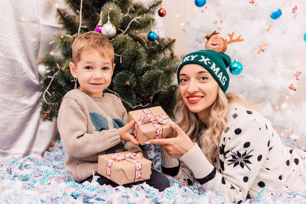 Happy mom with little son celebrate christmas