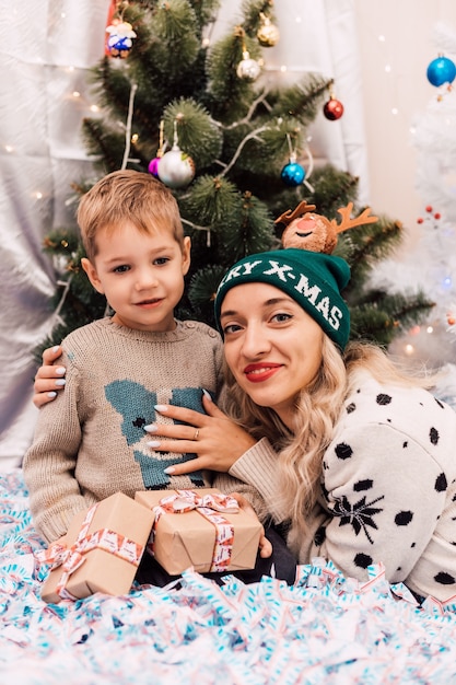 Happy mom with little son celebrate christmas