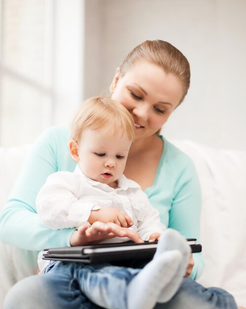 happy mother and adorable baby with tablet pc