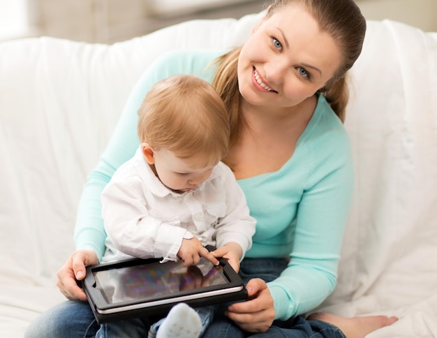 happy mother and adorable baby with tablet pc