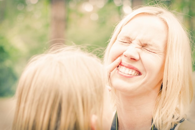 Photo happy mother a blond woman laughs toned