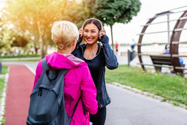 Happy mother and daughter enjoying in walk outdoors in park.