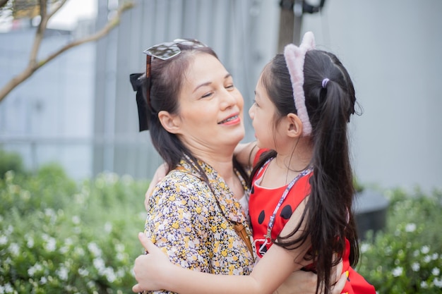 Happy mother and daughter in garden