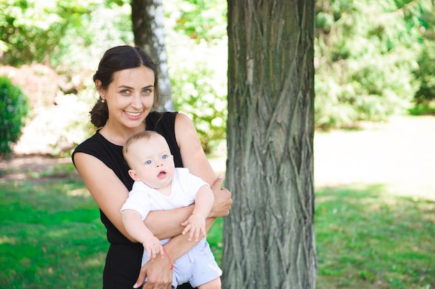 Happy mother and daughter laughing together outdoors