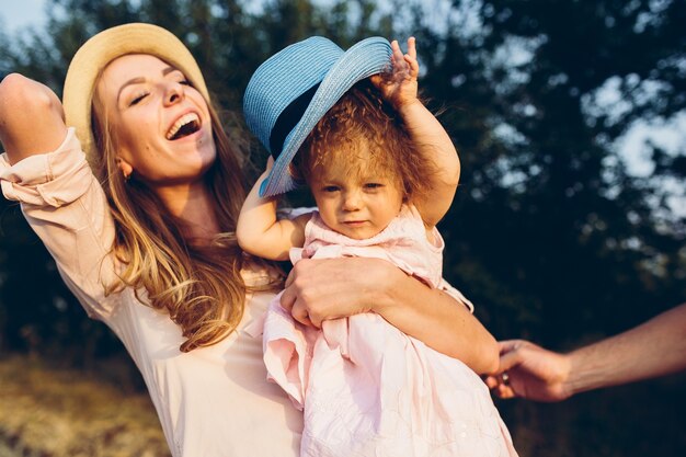 Happy mother and daughter laughing together outdoors