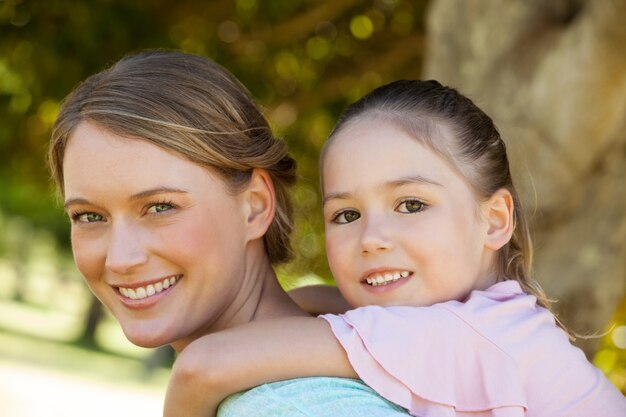 Happy mother and daughter at park