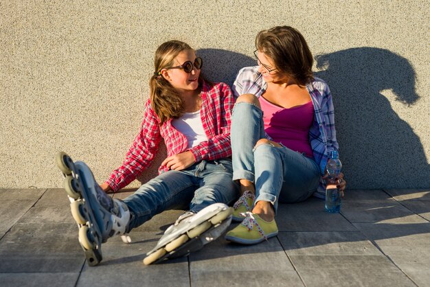 Happy mother and daughter talking outdoors