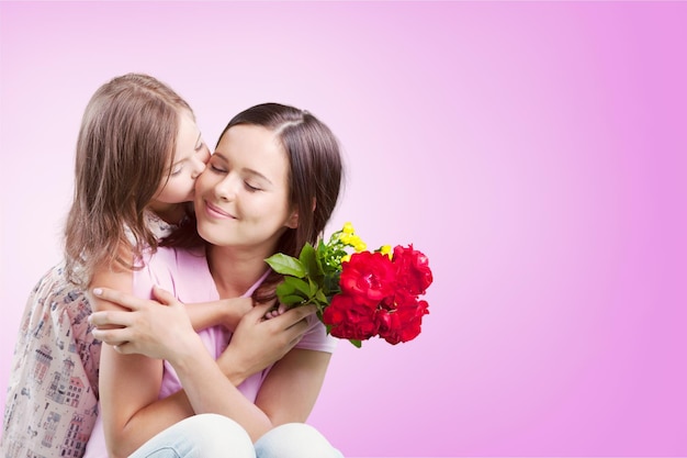 Happy Mother and daughter together with flowers