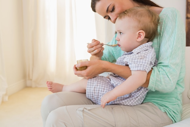 Happy mother eating with her baby boy