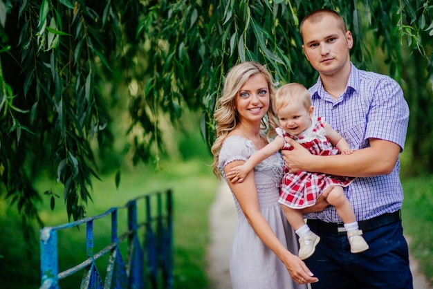 Happy mother, father and daughter in the park