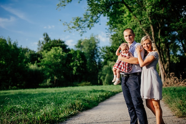 Happy mother, father and daughter in the park