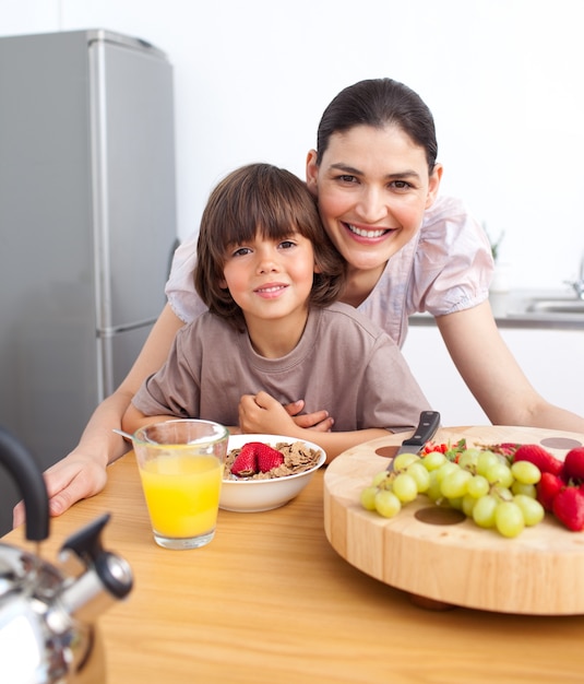 Happy mother and her child having breakfast 