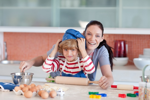 Happy mother and her son baking at home