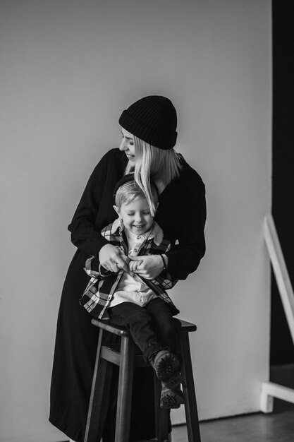 Happy mother and her son smiling and embracing in room