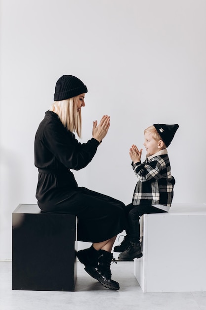 Happy mother and her son smiling and embracing in room