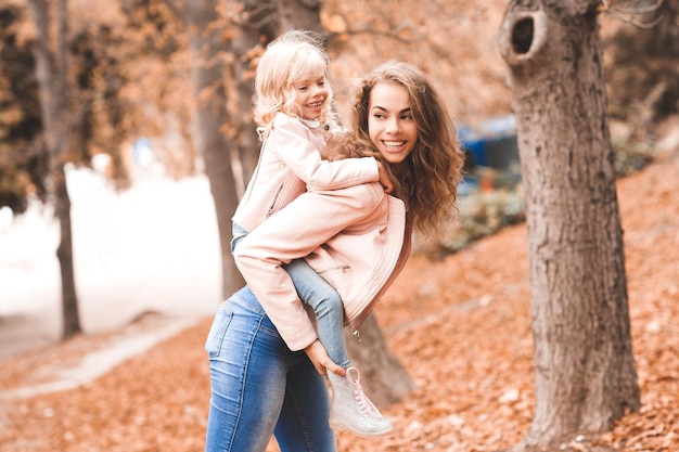 Happy mother holding baby girl in park