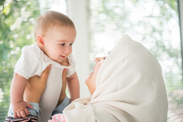 Happy mother holding a baby