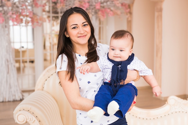 Happy mother holding her baby at home