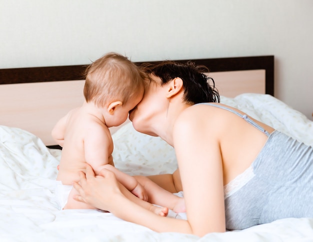 Happy mother holding her baby.mom kisses her baby