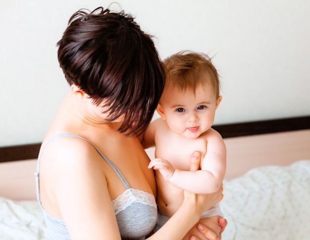 Happy mother holding her baby.mom kisses her baby