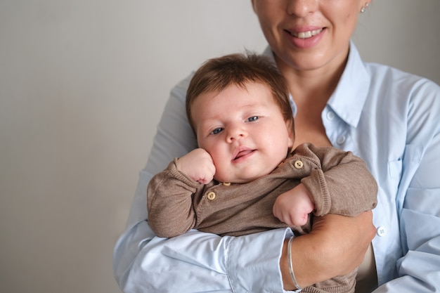 Foto madre felice che tiene piccola neonata sorridente. allattamento bambino. famiglia felice. a casa. amore. dolce. tenerezza. goditi il tempo trascorso insieme. foto di alta qualità