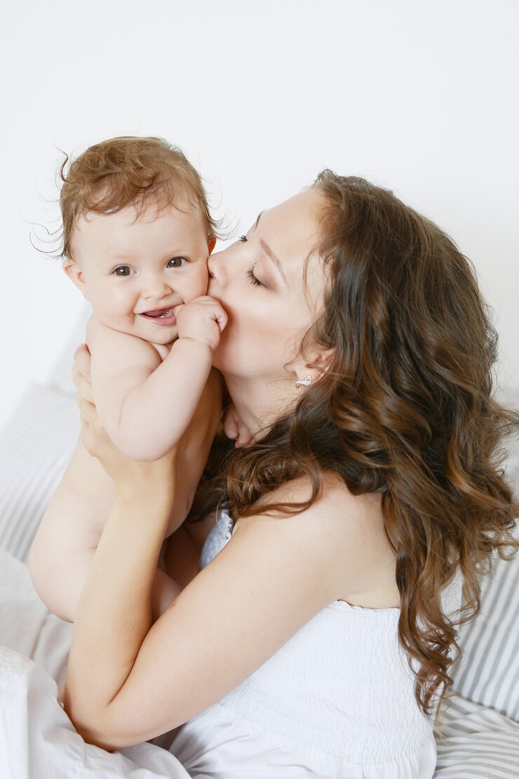 Happy mother hugging her adorable little daughter