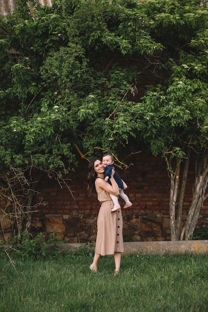 Happy mother and little daughter playing together in a park