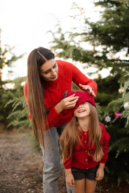 Happy mother play with kid girl daughter outdoors