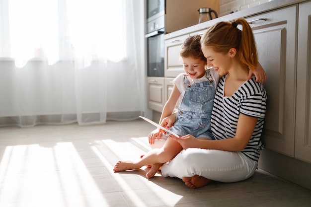 Happy mother's day child daughter congratulates her mother and read postcard